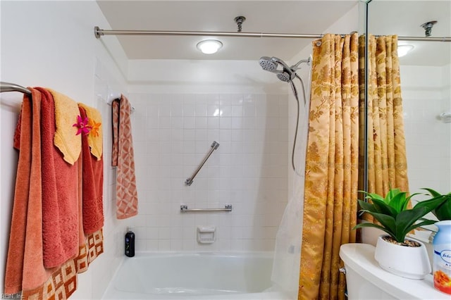 bathroom featuring shower / bath combo with shower curtain and toilet