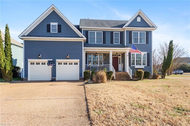 view of front of property with a front lawn, covered porch, and a garage