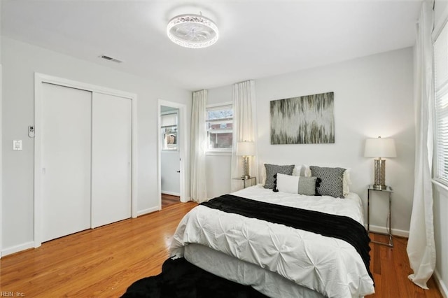 bedroom with hardwood / wood-style floors and a closet