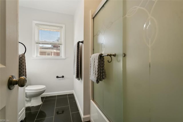 bathroom featuring tile patterned floors, toilet, and enclosed tub / shower combo