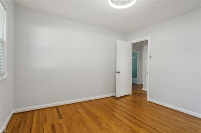 unfurnished room with light wood-type flooring