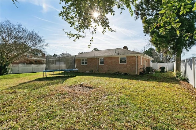 exterior space featuring a lawn and a trampoline