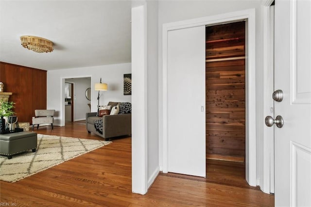 corridor featuring wood walls and hardwood / wood-style floors