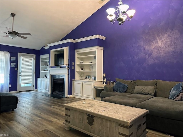 living room with ceiling fan with notable chandelier, wood-type flooring, built in features, and lofted ceiling