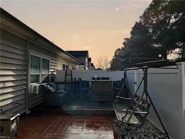 deck at dusk featuring a patio area