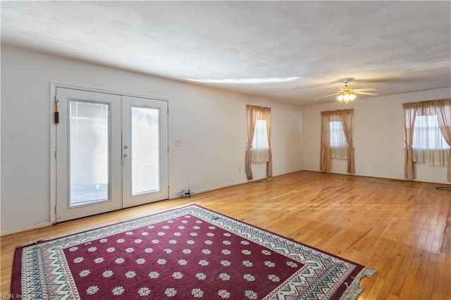 interior space featuring ceiling fan, french doors, and hardwood / wood-style floors