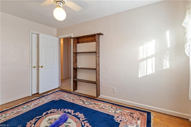 unfurnished bedroom with hardwood / wood-style flooring and ceiling fan