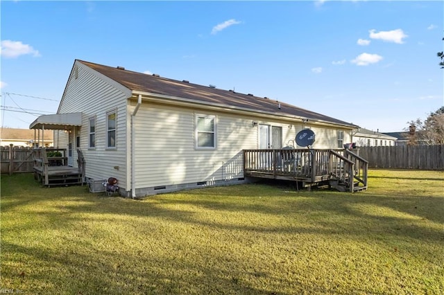 back of house with a lawn and a wooden deck