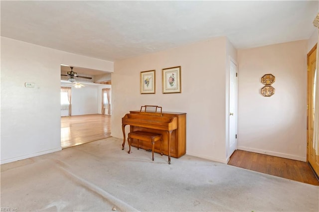 misc room with ceiling fan and light wood-type flooring