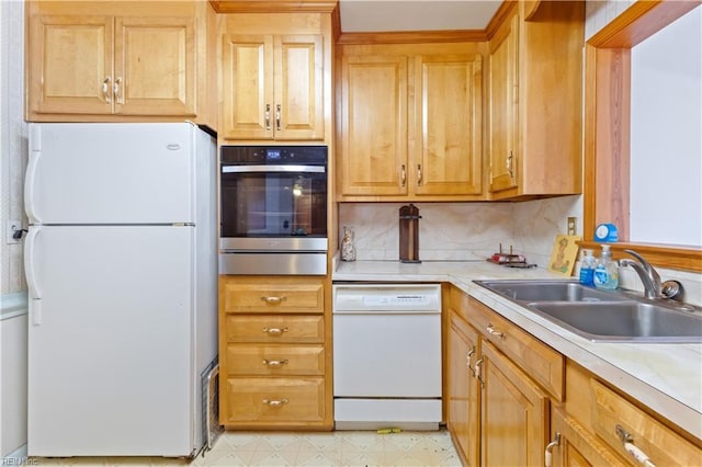 kitchen featuring tasteful backsplash, sink, and white appliances