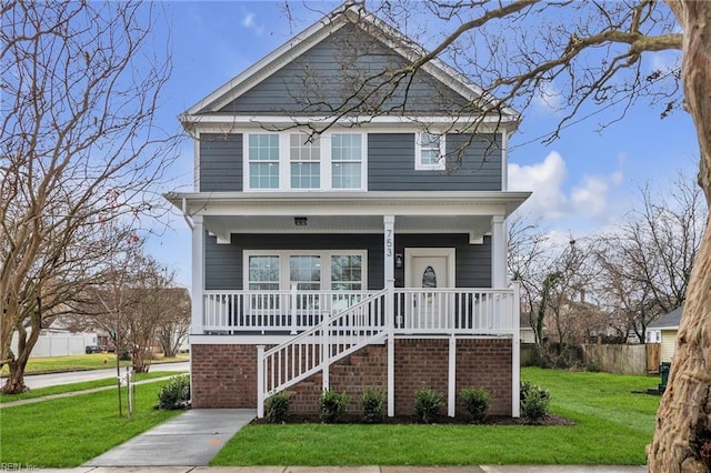 view of front of home featuring a front yard and a porch