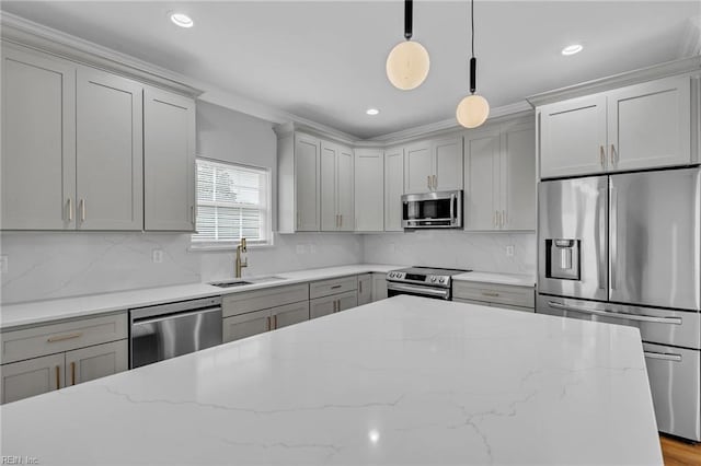 kitchen with appliances with stainless steel finishes, decorative backsplash, hanging light fixtures, and sink