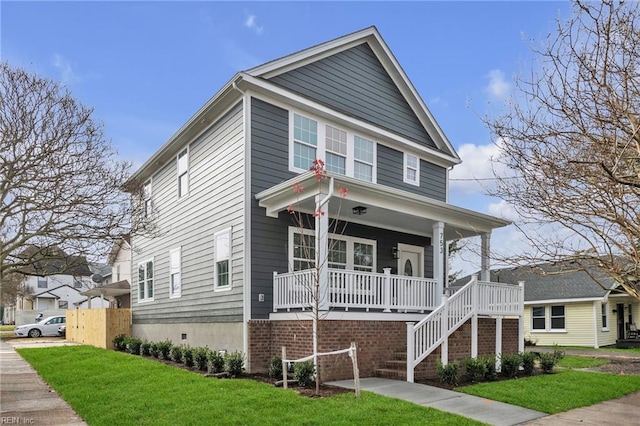 view of front of home featuring covered porch and a front yard