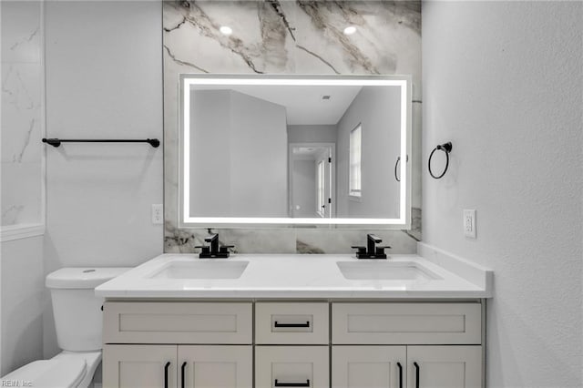 bathroom featuring toilet and vanity