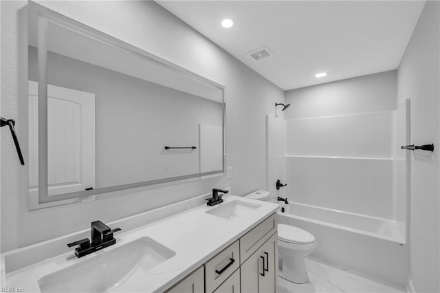 full bathroom featuring washtub / shower combination, toilet, and vanity