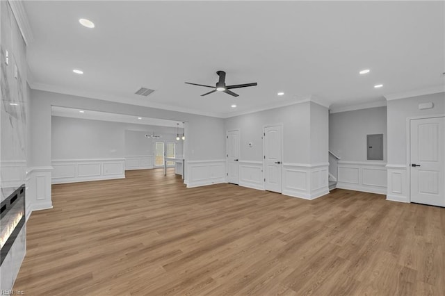 unfurnished living room featuring ceiling fan, light wood-type flooring, and ornamental molding