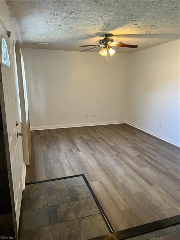 unfurnished room featuring ceiling fan, hardwood / wood-style floors, and a textured ceiling