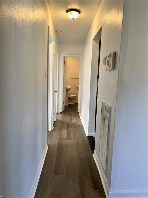 hallway with dark hardwood / wood-style floors