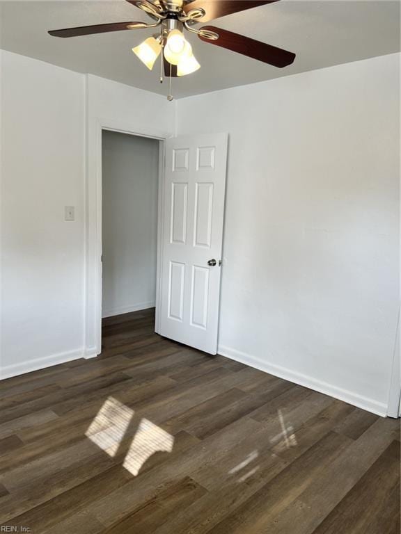 unfurnished room with dark hardwood / wood-style flooring