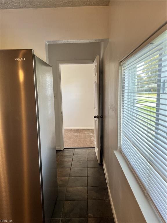 corridor featuring dark tile patterned floors