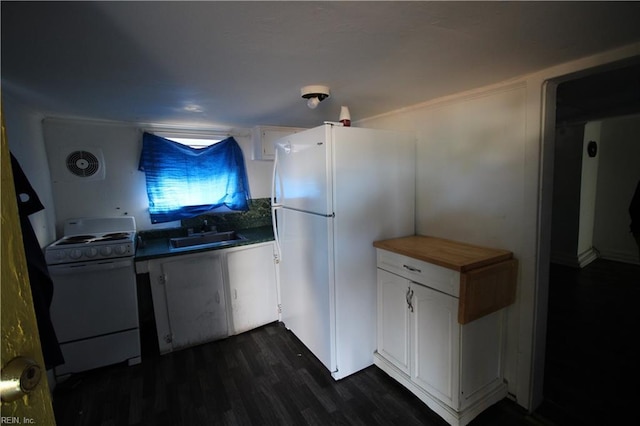 kitchen with white cabinetry, sink, dark hardwood / wood-style flooring, butcher block countertops, and white appliances