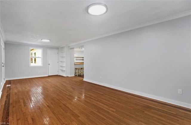 unfurnished room with hardwood / wood-style flooring and crown molding