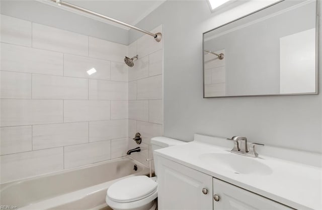 full bathroom with vanity, tiled shower / bath combo, and toilet