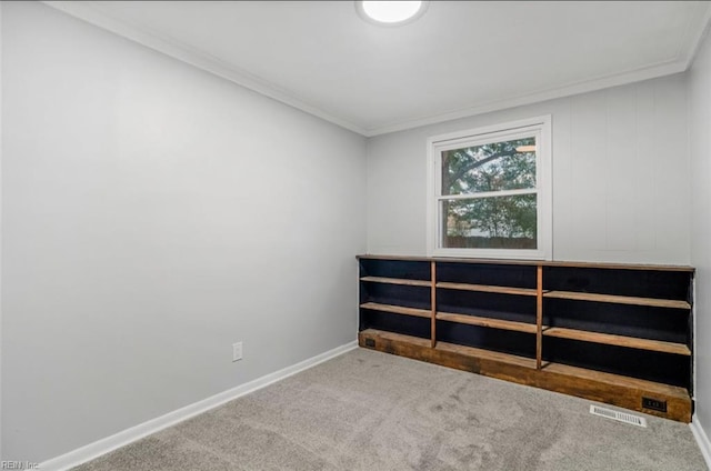 carpeted spare room with crown molding