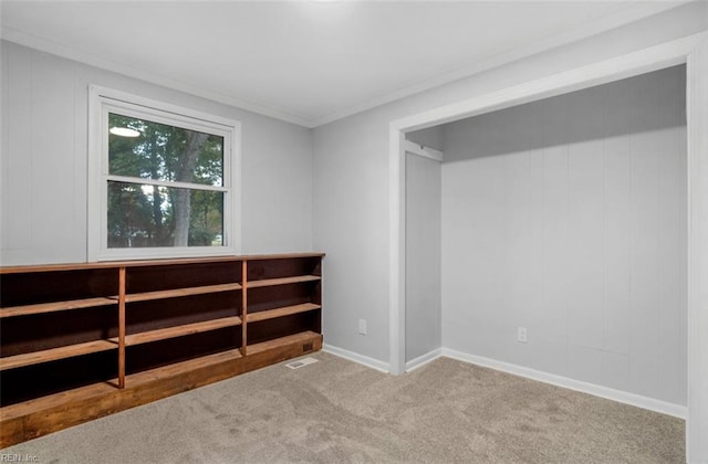 carpeted empty room with crown molding