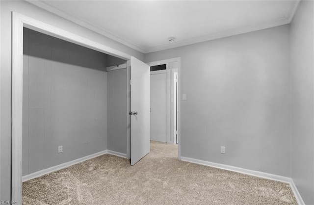 unfurnished bedroom with ornamental molding and light carpet