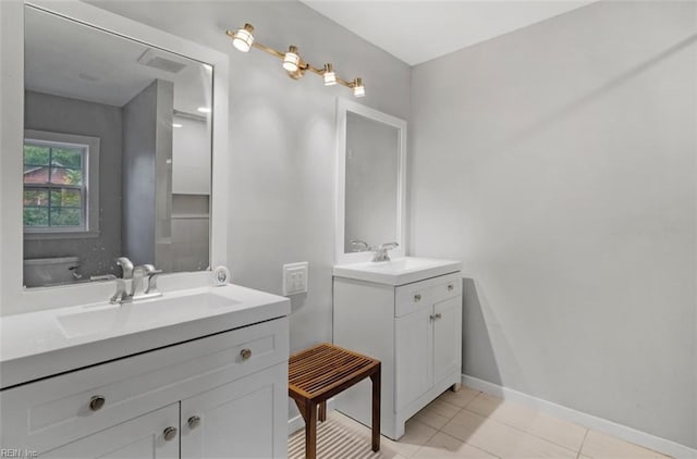 bathroom featuring toilet, vanity, and tile patterned floors