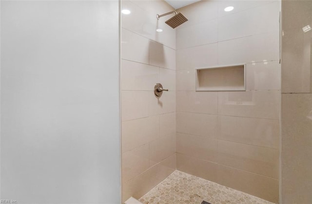 bathroom with tiled shower