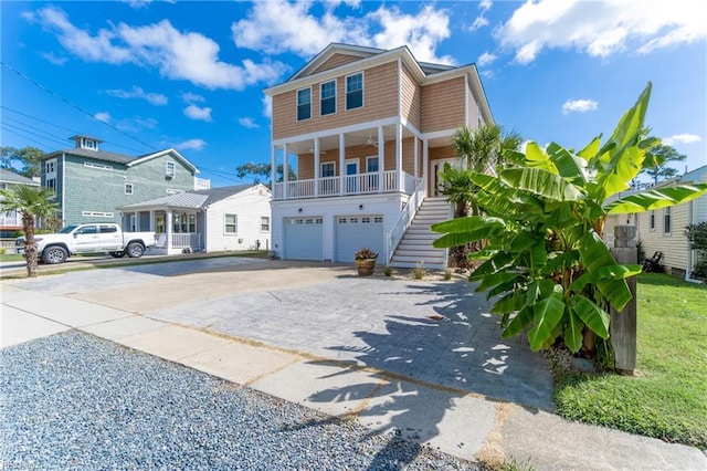 view of front facade featuring a front yard, a porch, and a garage