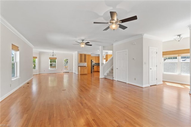 unfurnished living room featuring ceiling fan with notable chandelier, light hardwood / wood-style floors, and ornamental molding