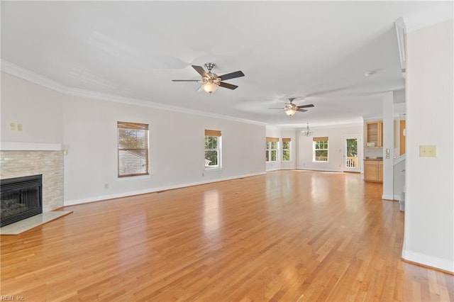 unfurnished living room featuring light hardwood / wood-style floors, ceiling fan, and crown molding