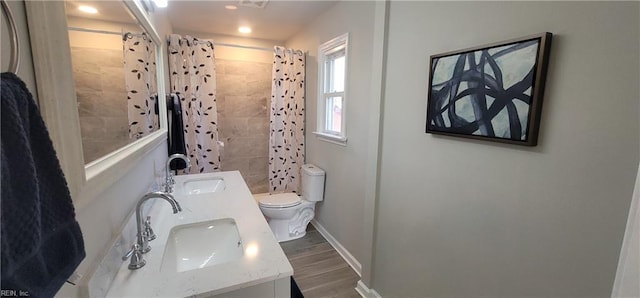 bathroom featuring a shower with curtain, hardwood / wood-style floors, vanity, and toilet