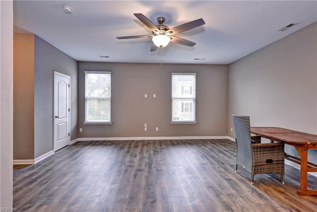 interior space with ceiling fan and dark hardwood / wood-style flooring