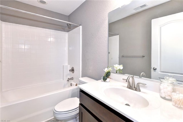 full bathroom with toilet, vanity, and washtub / shower combination