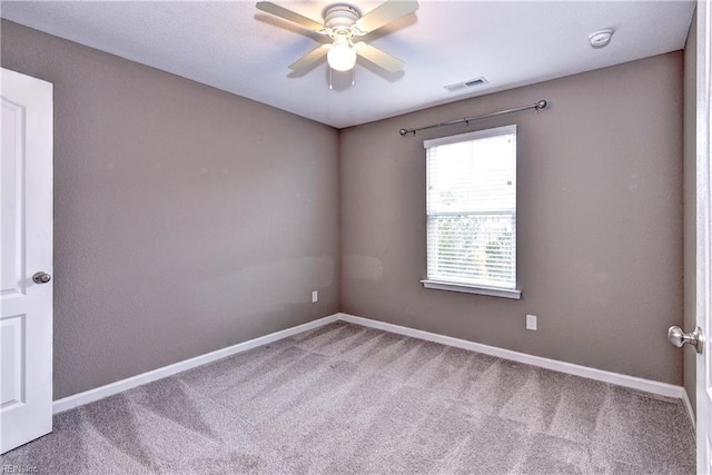 spare room with carpet floors and ceiling fan