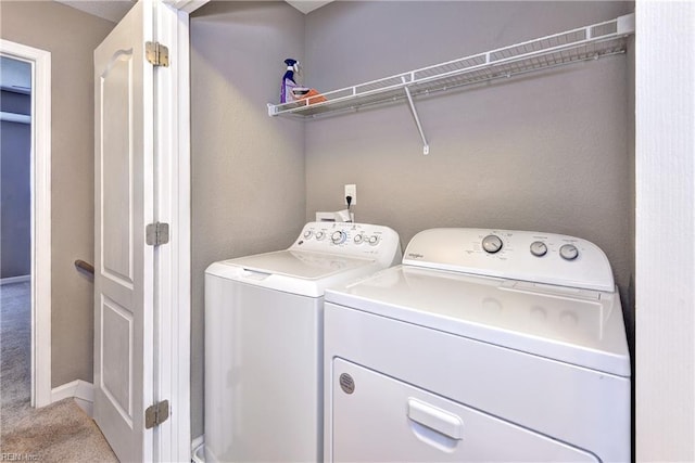 laundry room featuring independent washer and dryer and light carpet