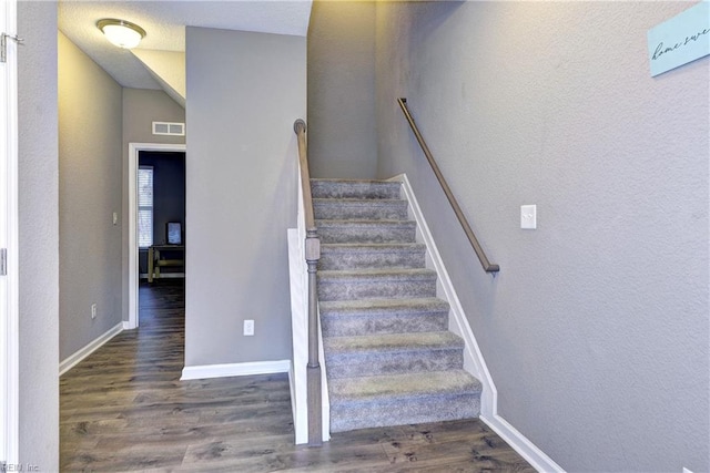 stairs with wood-type flooring