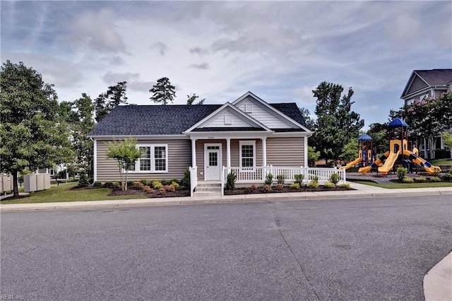 view of front of property with a playground