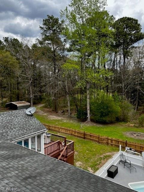 wooden terrace with a lawn