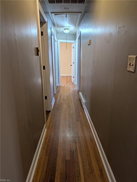 hall featuring baseboard heating and hardwood / wood-style floors