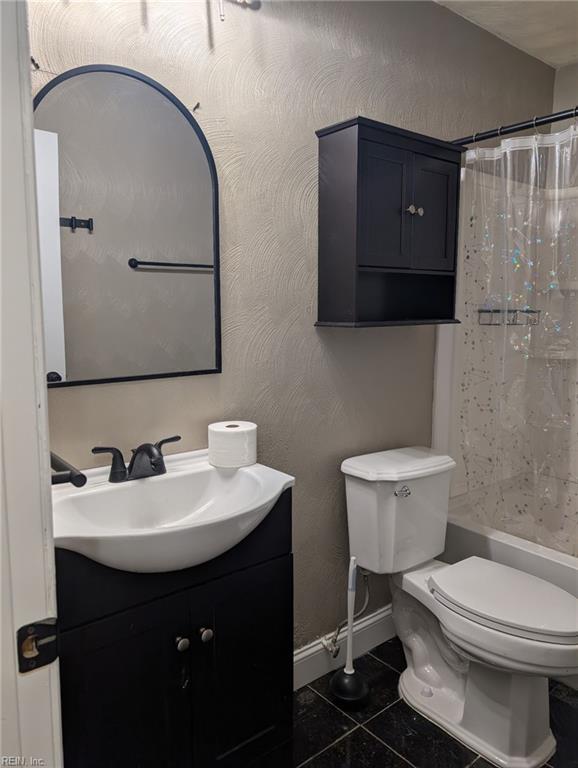 bathroom with tile patterned floors, toilet, and vanity