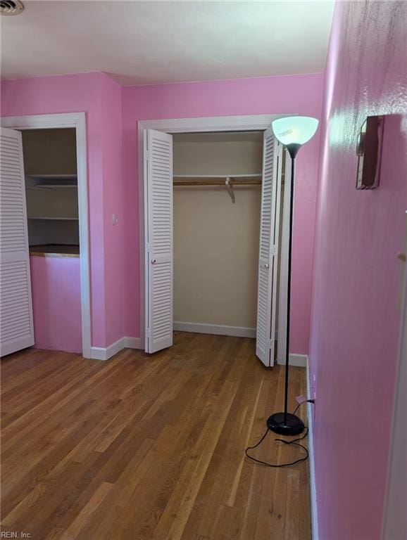 unfurnished bedroom with wood-type flooring