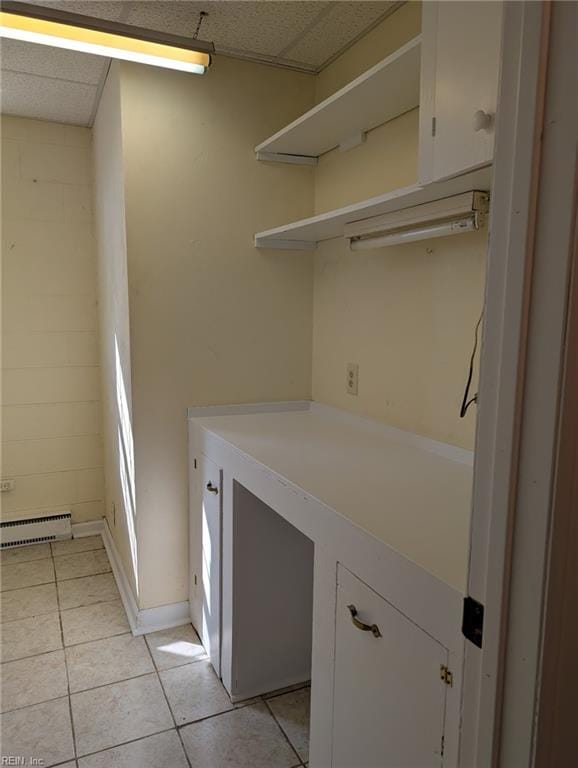 washroom with a baseboard radiator and light tile patterned floors