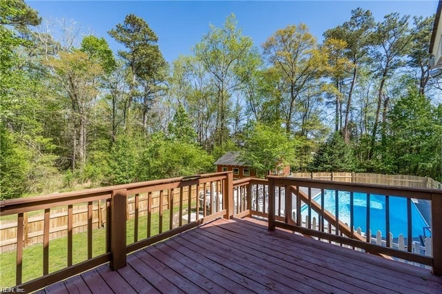 deck featuring a fenced in pool