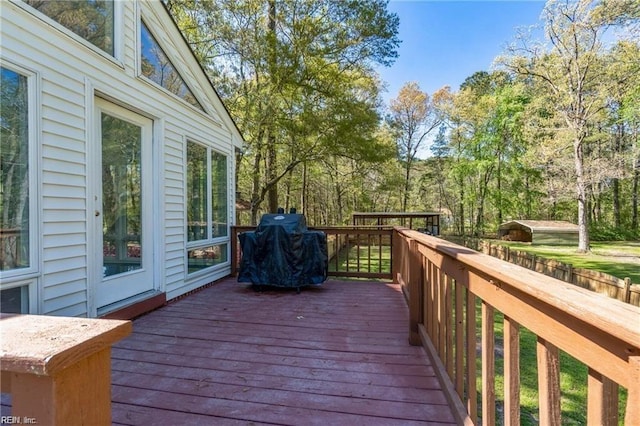 wooden terrace with a grill