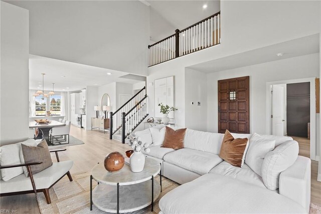 living room with light hardwood / wood-style flooring and a high ceiling